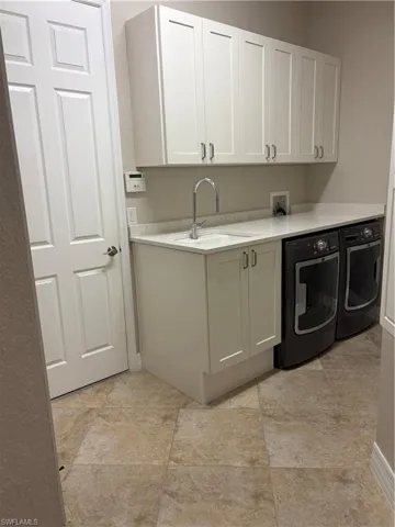 Laundry area featuring cabinet space and washer and dryer