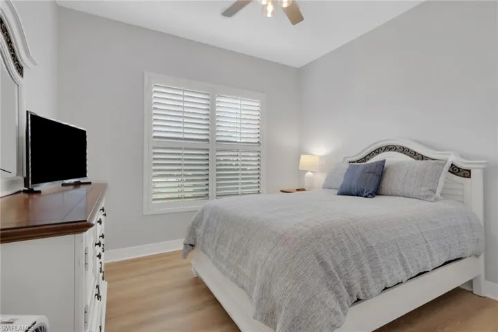 Bedroom with light wood finished floors and a ceiling fan