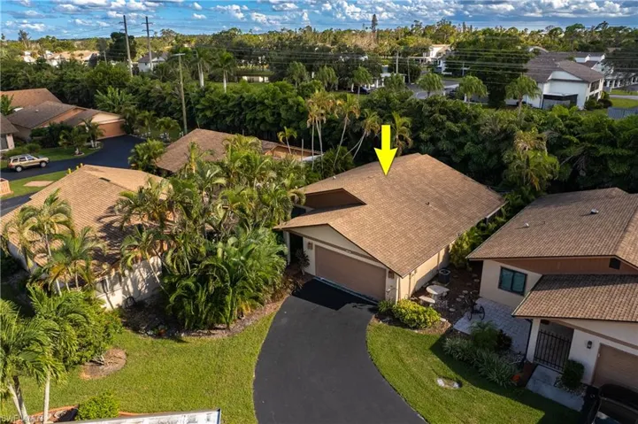 Aerial view of residential area featuring a tree filled landscape
