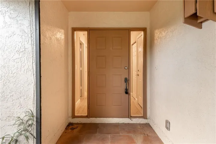 Entrance to property with stucco siding