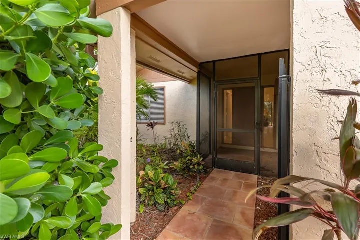 Entrance to property with stucco siding