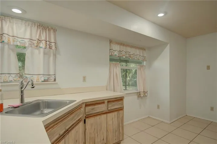 Kitchen with recessed lighting, light brown cabinetry, light countertops, and light tile patterned flooring