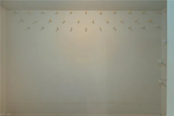 Master bedroom closet.  Pegs on wall were used to hang owners caps.