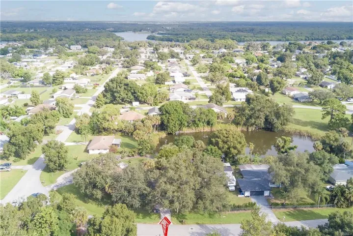 Aerial view of property's location with a large body of water and nearby suburban area
