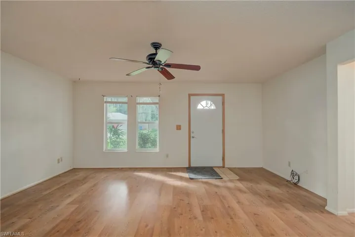 Entrance foyer with light wood-type flooring and ceiling fan