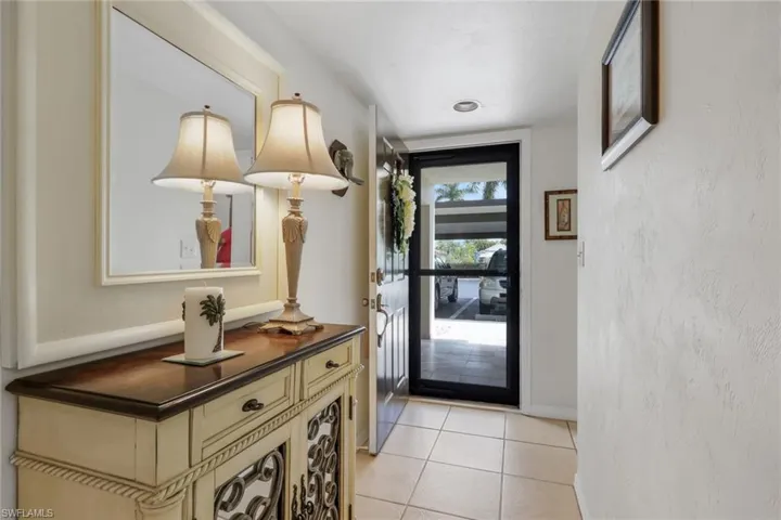 Doorway to outside featuring baseboards and tile patterned floors