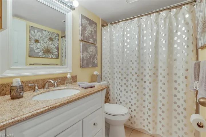 Guest bathroom with vanity, a shower with shower/tub combo