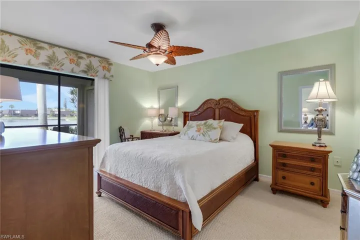 Primary bedroom with water view and access to the lanai