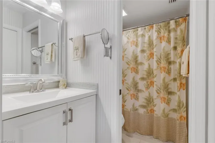 Updated primary bathroom with vanity and step in shower