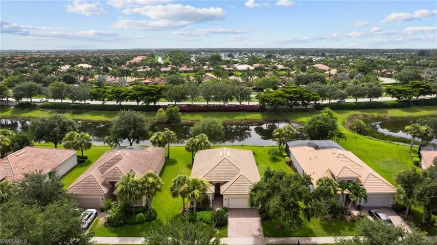 Birds eye view of property with a water view