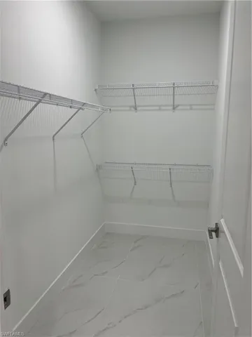 Spacious closet featuring tile floors