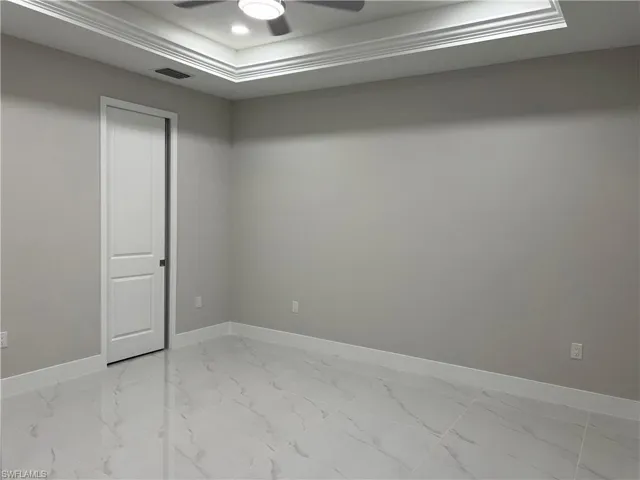 Spare room featuring ceiling fan and tile floors