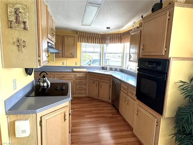 Kitchen featuring extra storage and light wood-type flooring