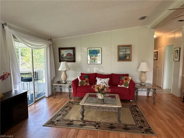 Living room wood-style floors, and vaulted ceiling