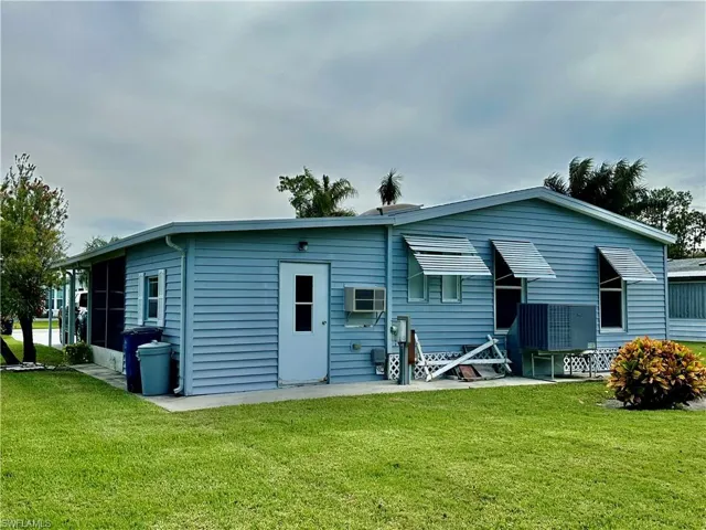 Back of house with a spacious lot