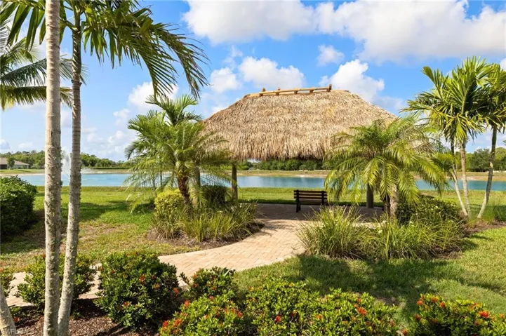 Surrounding community featuring a water view and a lawn
