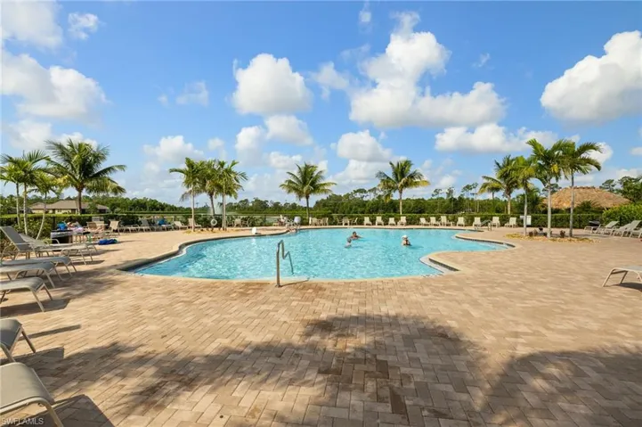 Community pool with a patio