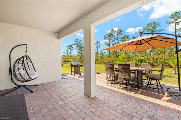 View of patio featuring outdoor dining space and a grill