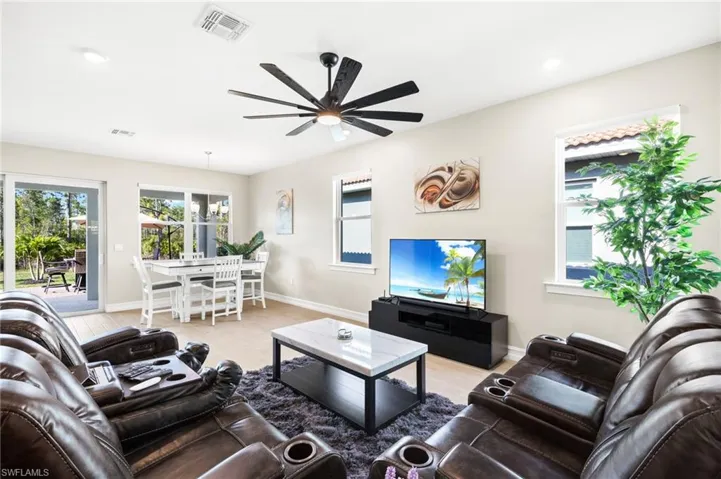 Living room with ceiling fan and wood finished floors