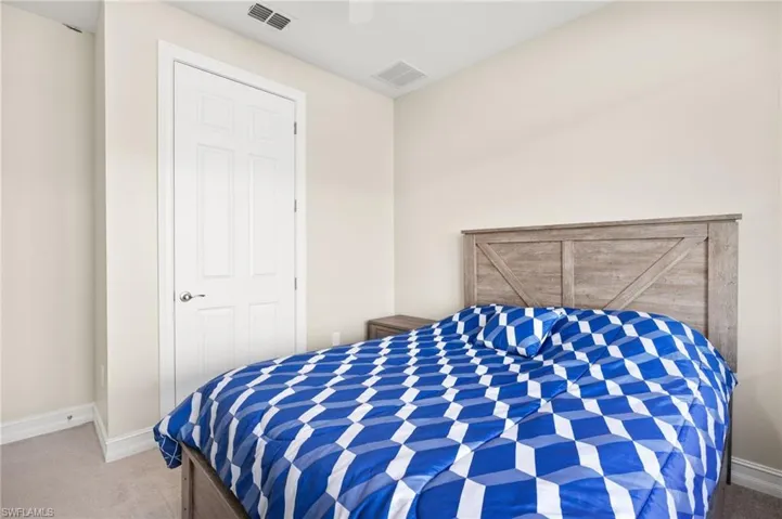 Carpeted bedroom featuring baseboards and a ceiling fan