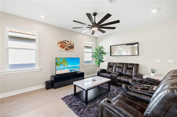 Living area with ceiling fan, light wood-type flooring, and recessed lighting