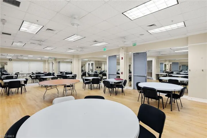 Dining area featuring light wood-style flooring and a drop ceiling
