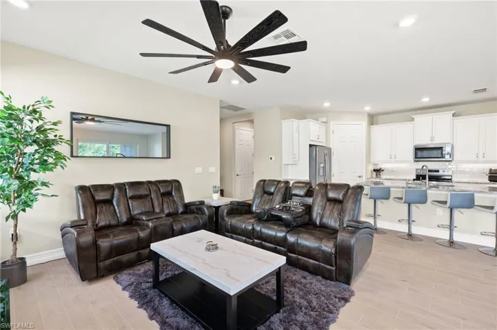 Living room featuring ceiling fan, light wood-type flooring, and recessed lighting