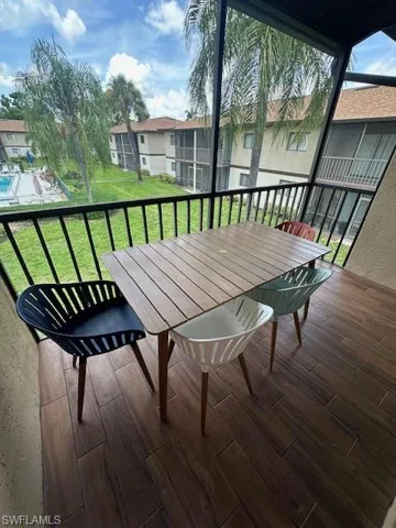 Screened in patio over looking landscaped area and pool