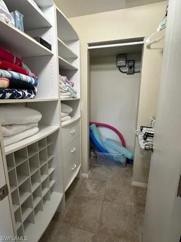 Master Spacious closet featuring tile patterned flooring