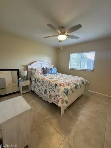 Tiled bedroom with ceiling fan