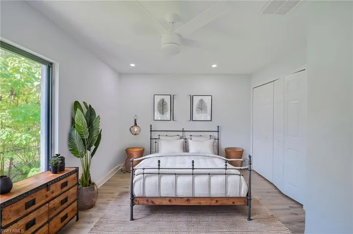 Interior space featuring wood-finish flooring, a ceiling fan with integrated lighting, recessed lighting, and a multi-panel sliding closet