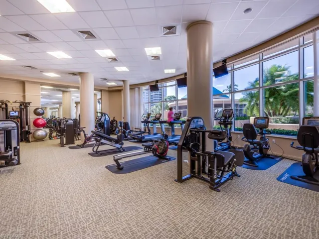 Workout area featuring a paneled ceiling and carpet floors