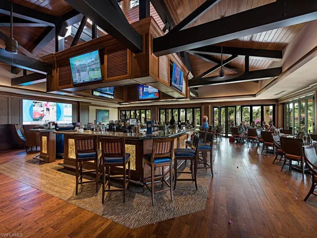 Bar featuring hardwood / wood-style floors, beam ceiling, wooden ceiling, and high vaulted ceiling