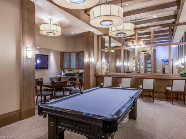 Rec room with a towering ceiling, carpet, and billiards