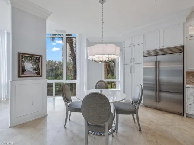 Dining room featuring an inviting chandelier and ornamental molding
