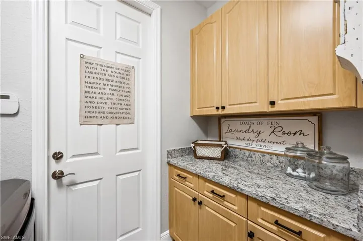 Amazing Storage In This Spacious Updated Laundry Room With New Granite, New Deep Utility Sink, Fixtures, Custom Back Splash & Wall-To-Wall Offering Abundance Of Storage!