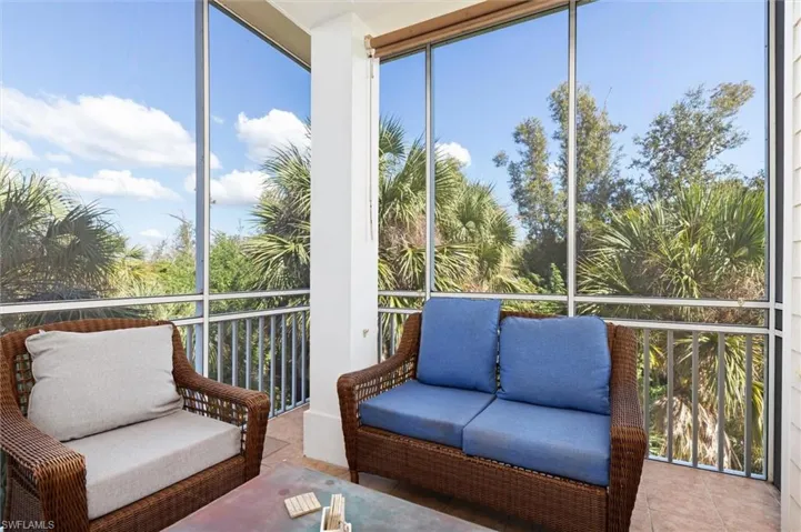 Sunroom / solarium featuring expansive windows, plenty of natural light, and tile patterned floors