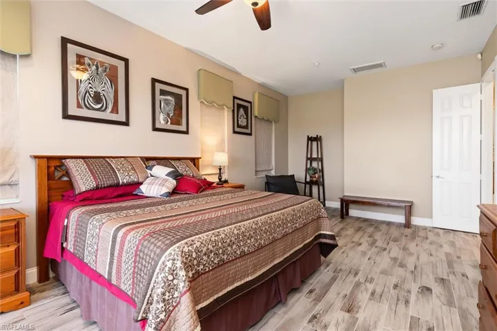 Bedroom with wood tiled floors and ceiling fan