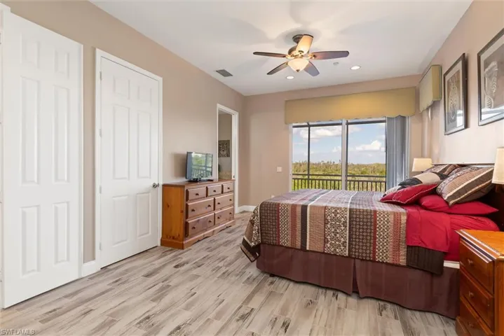 Bedroom featuring access to exterior, light wood-style floors, ceiling fan, and recessed lighting