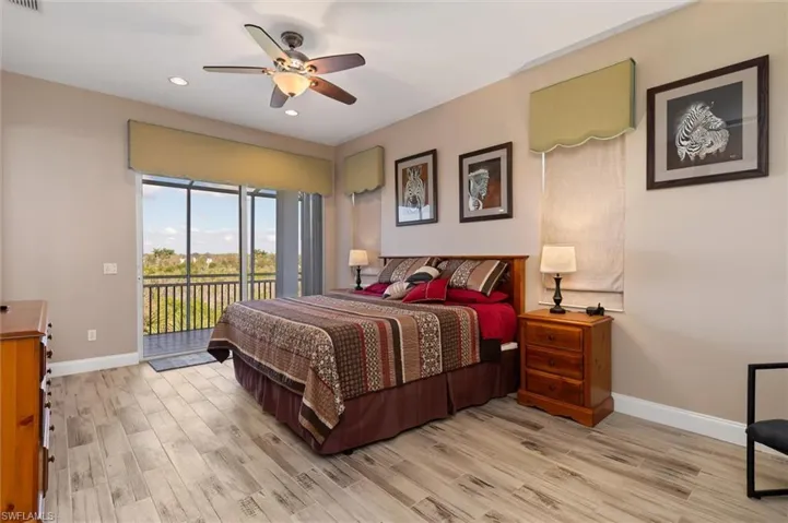 Bedroom featuring access to outside, light wood-style floors, a ceiling fan, and recessed lighting