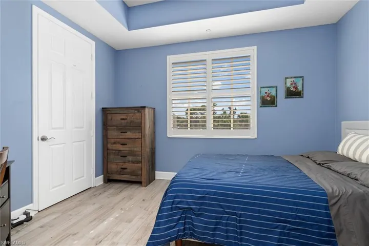 Bedroom featuring wood finished floors and baseboards