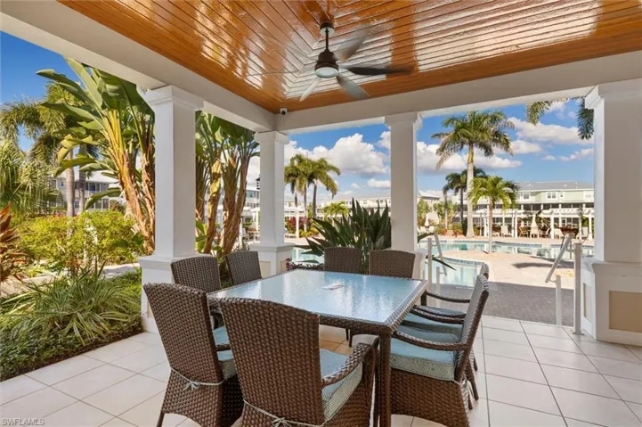 View of patio / terrace with a community pool, ceiling fan, and outdoor dining area