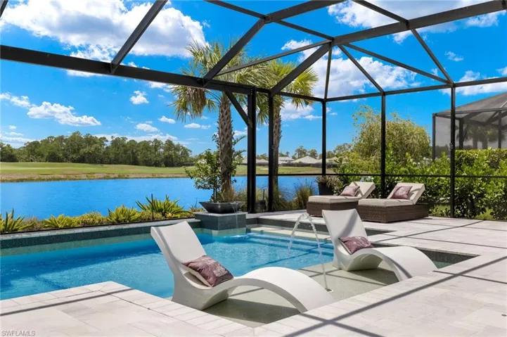View of pool featuring a water view, a lanai, a patio area, and pool water feature