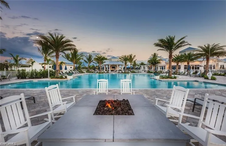Pool at dusk with a patio area