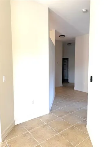 Spare room with light tile patterned floors