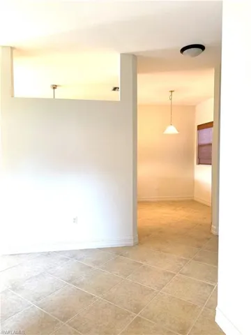 Unfurnished room featuring baseboards and light tile patterned floors