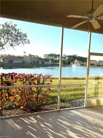 Unfurnished sunroom with a water view and a residential view