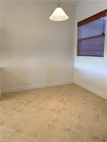 Unfurnished room with baseboards and light tile patterned floors