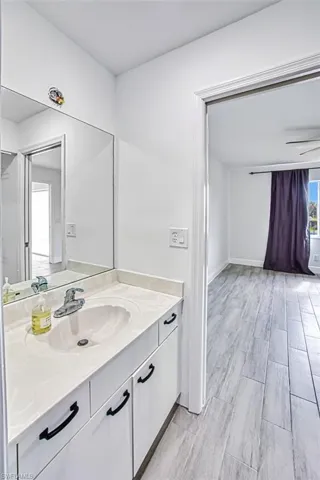 Bathroom featuring hardwood / wood-style flooring and vanity