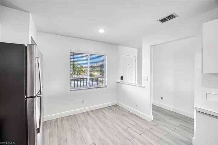 Unfurnished dining area with light hardwood / wood-style flooring